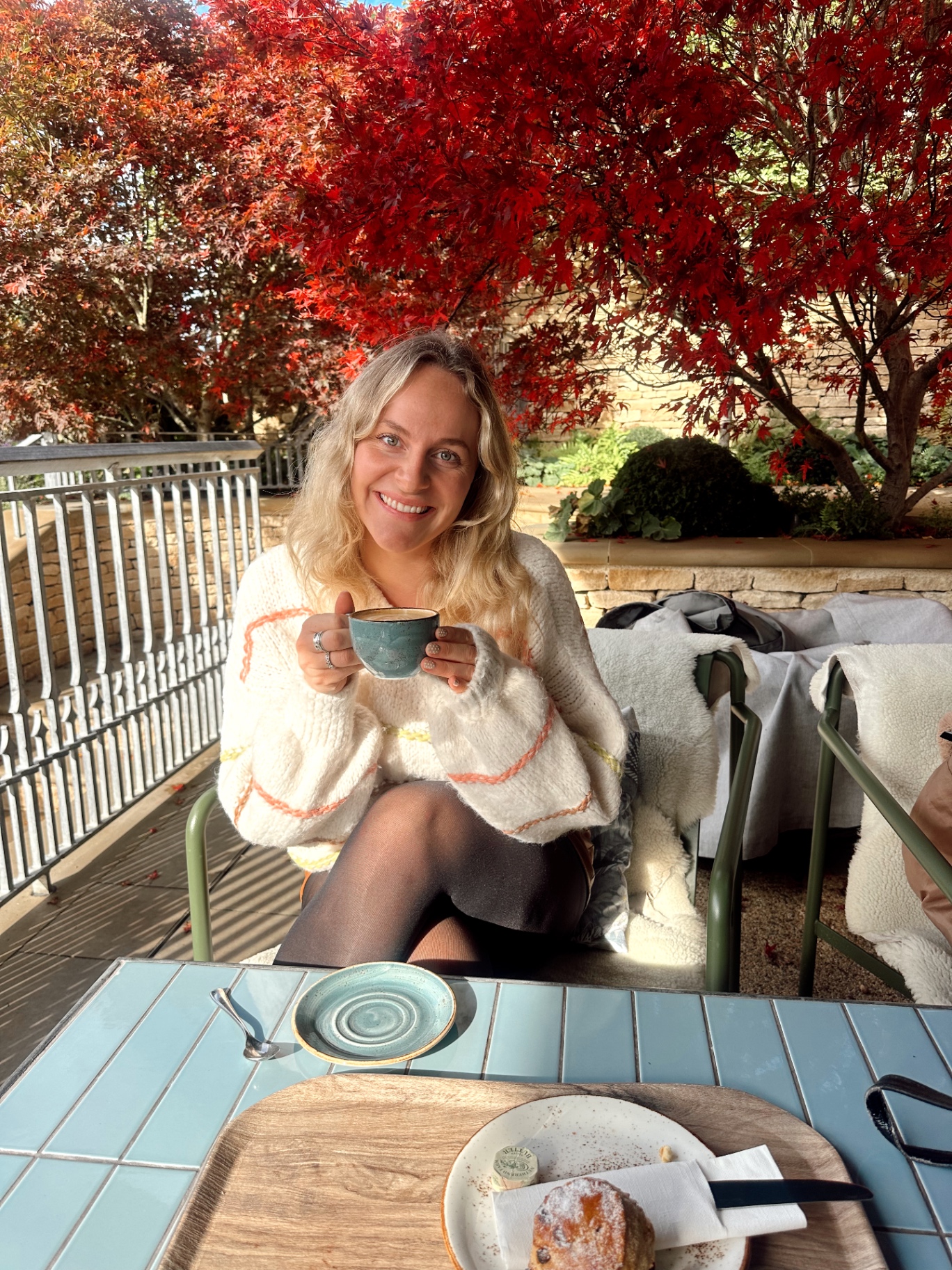 Coffee under a red Japanese maple in autumn
